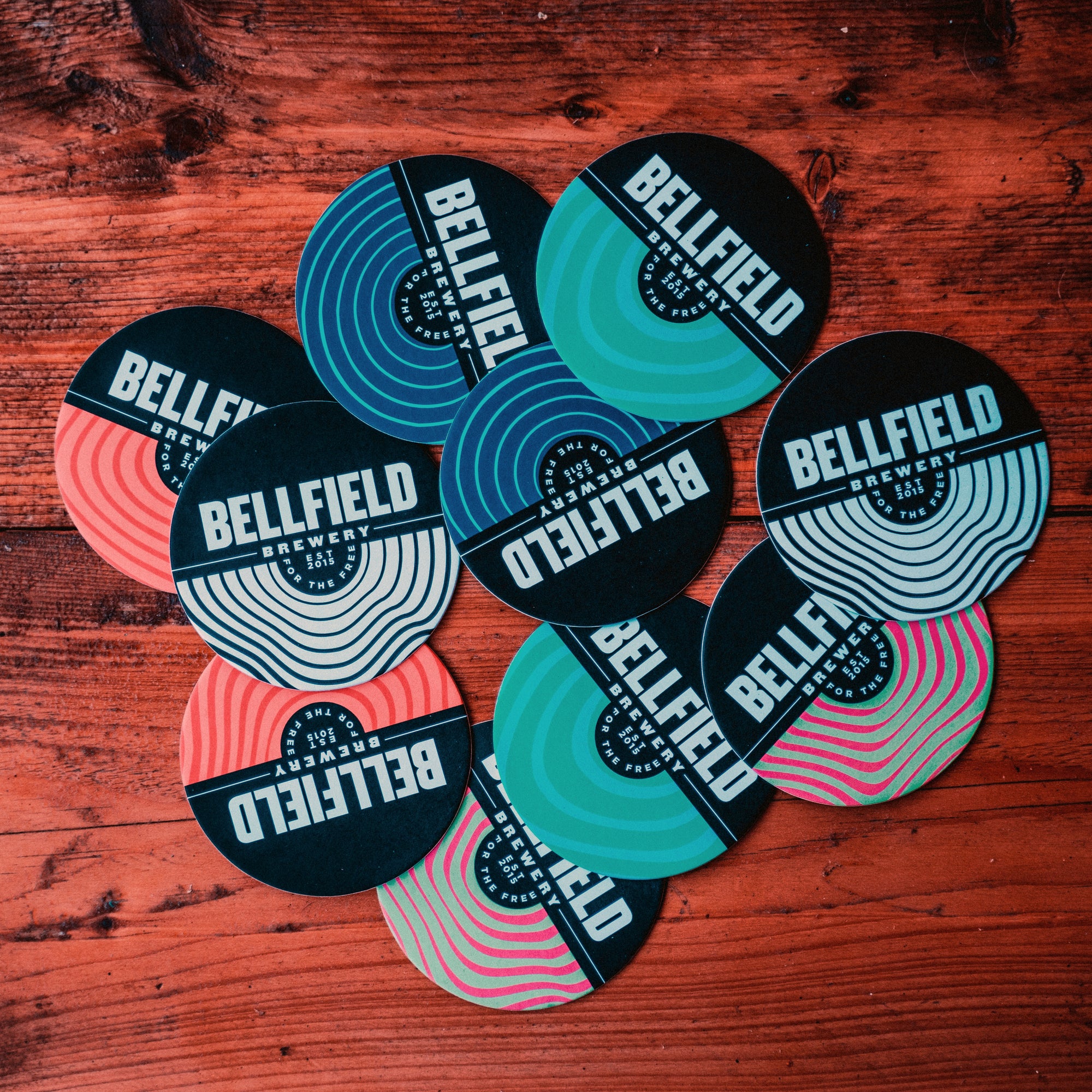 Assorted circular Bellfield beermats.