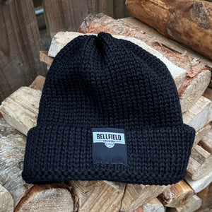 A black Bellfield beanie hat.