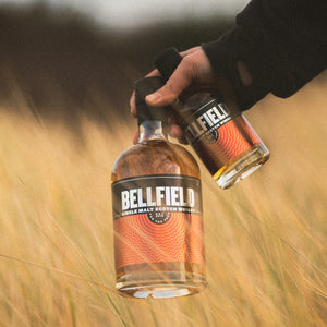 70cl and 20cl bottles of Single Malt Scotch Whisky in a field of barley.