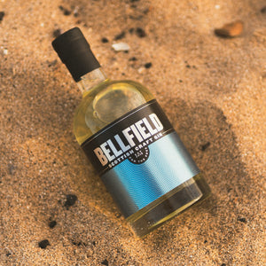 70cl bottle of Scottish Craft Gin on a beach. 